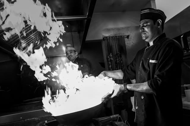 Chef de Chi cocinando al wok con una gran flama